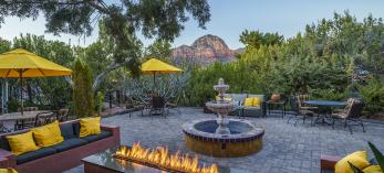 The patio area of A Sunset Chateau includes a fountain, firepit and a view of the nearby red rocks of Sedona. | Laurence Parent