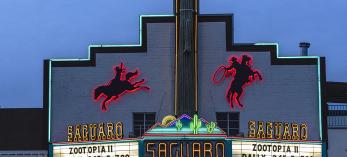 The facade of the Saguaro Theater in Wickenburg features backlit silhouetted figures of mounted cowboys in action. By Mark Lipczynski