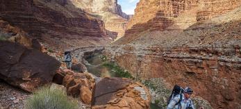 On the fifth day of the trip, author Kevin Fedarko (left) and photographer Pete McBride traverse a stretch of terrain across from 29 Mile Canyon. | RICH RUDOW
