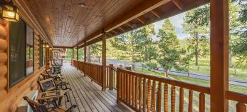 The long, wooden porch at Tal-Wi-Wi has plenty of chairs for guests to enjoy the White Mountains view. By Laurence Parent