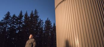 Father Paul Gabor, S.J., the vice director of the Vatican Observatory Research Group, looks to the heavens outside the Vatican Advanced Technology Telescope (VATT) building. Gabor calls the observatory atop Mount Graham “a very standard scientific institution.” | Bill Hatcher