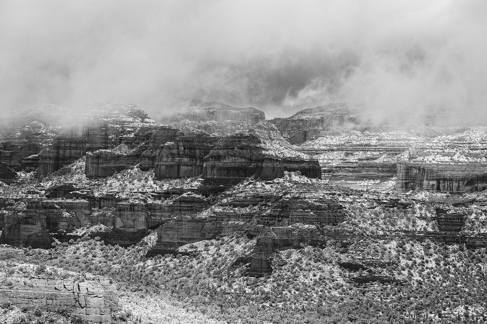 Photo by Diana Lustig  |  Fog and snow mix and fall over the mountain of Sedona. 