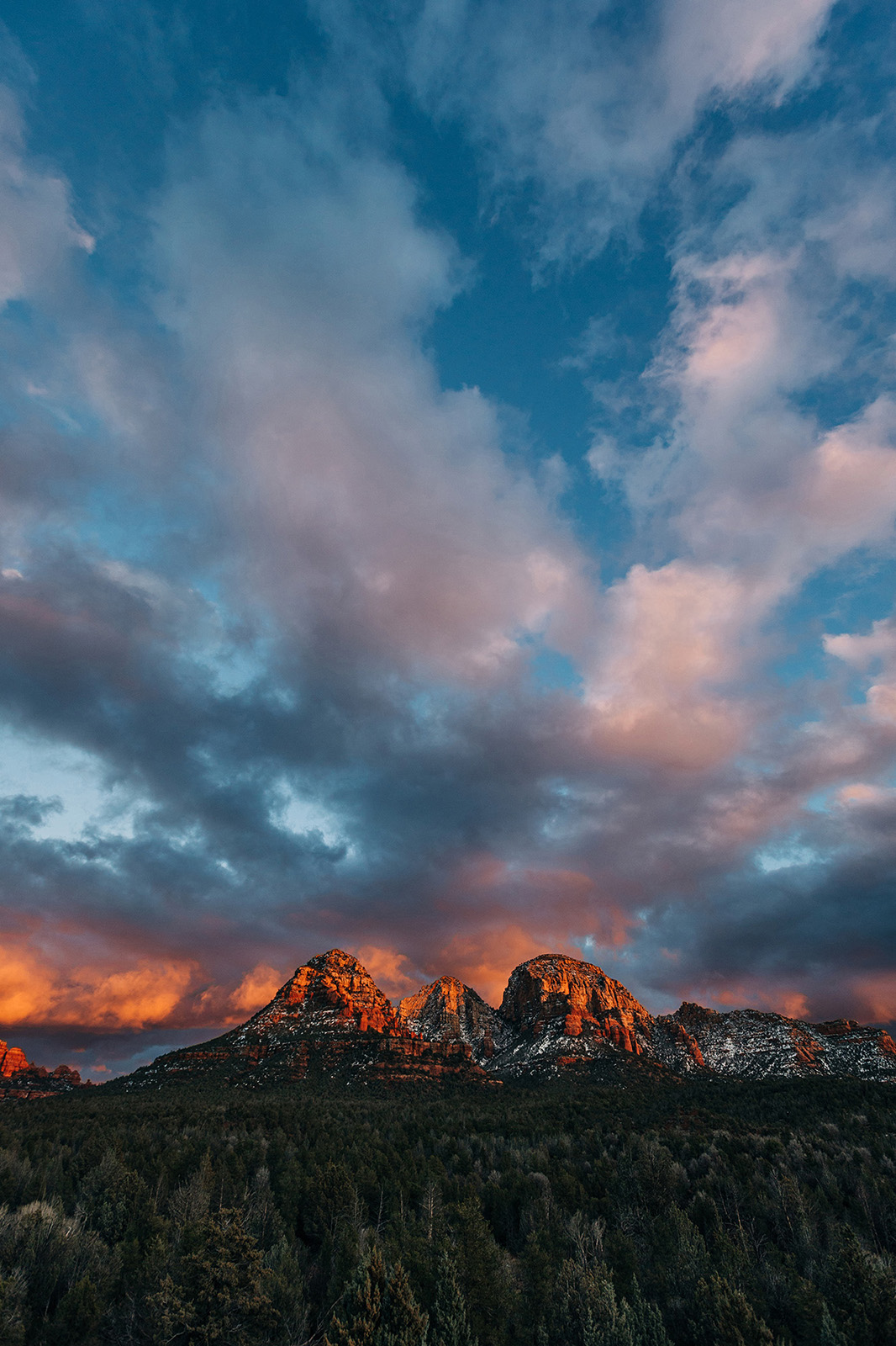 Photo by Diana Lustig  |  The sunset explodes in rich colors over the mountains of Sedona. 