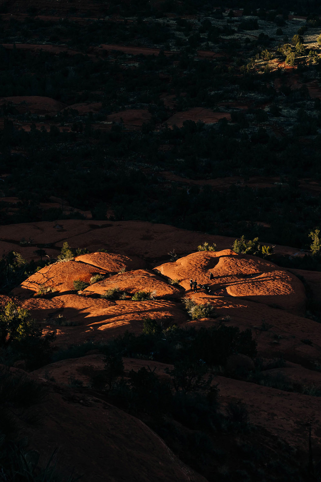 Photo by Diana Lustig  |  A pocket of sunlight hits the rocks below Bell Rock in Sedona