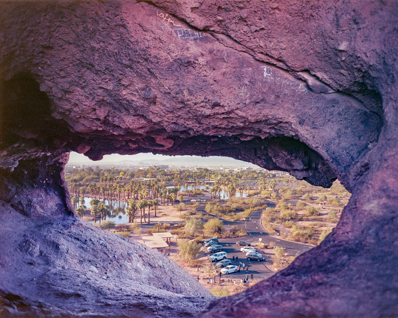 Photo by Kyle Conway  |  This photo shows modern-day Papago Park through the Hole-in-the-Rock window. Photographers have visited this spot for decades, and this gap has framed Phoenix throughout its history.