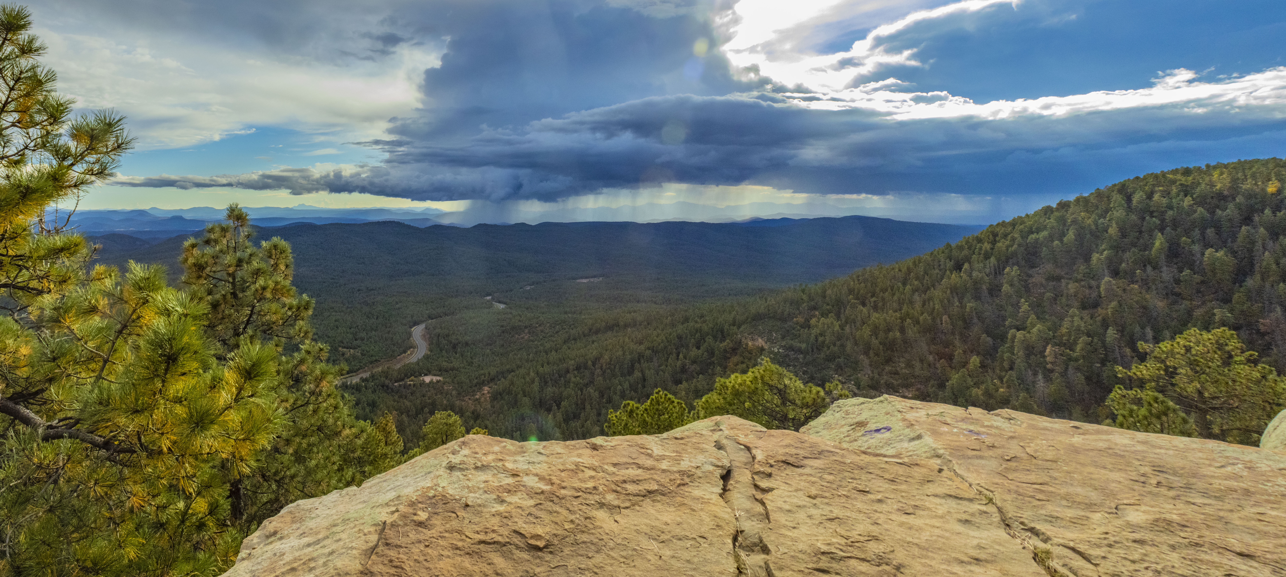 Photo by Kaylee Morello  |  This is a Panoramic Image of a Cliff in Prescott Arizona with a beautiful view of a huge rain cloud pouring down in the distance.