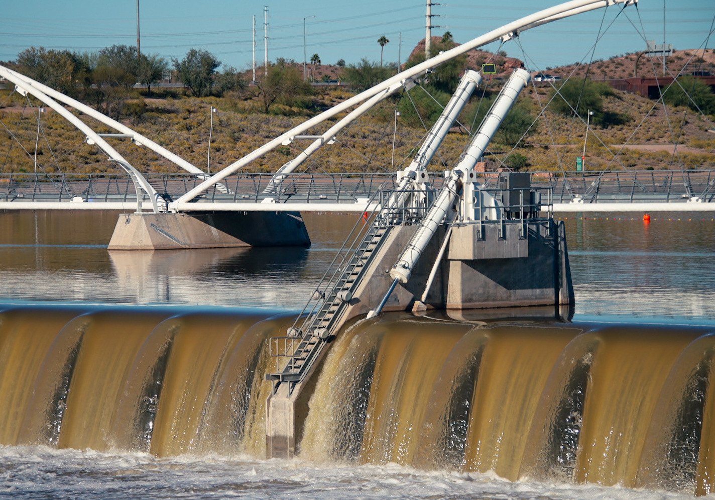 Photo by Tyler Kilmer  |  Tempe Town Lake Dam overflows as the snow melts from a snowy winter upstream.